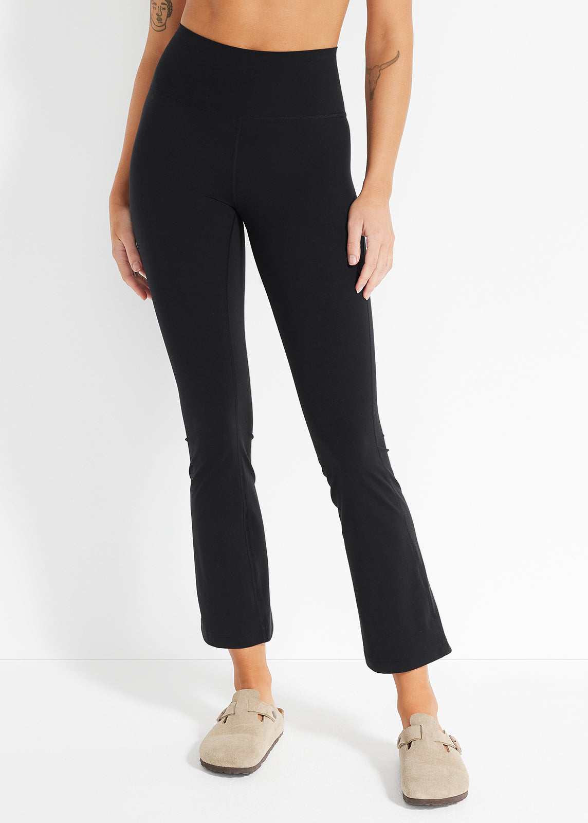 Model wearing black cropped flares